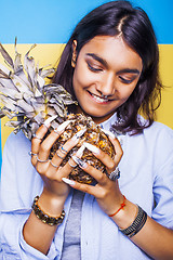 Image showing lifestyle people concept. young pretty smiling indian girl with pineapple, asian summer fruits 