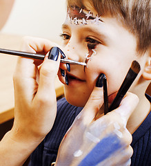 Image showing little cute child making facepaint on birthday party, zombie Apo