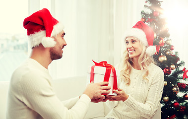 Image showing happy couple at home with christmas gift box