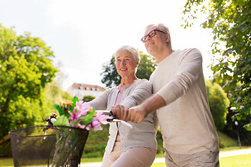 Image showing happy senior couple with bicycles at summer park