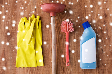 Image showing plunger with toilet cleaning stuff on wood