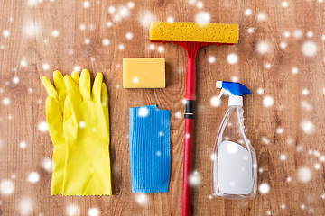 Image showing squeegee with window cleaning stuff on wood