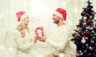 Image showing happy couple at home with christmas gift box