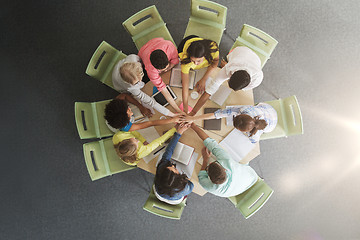 Image showing group of international students with hands on top