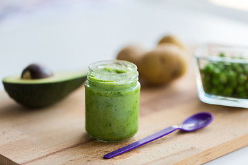 Image showing jar with puree or baby food on wooden board