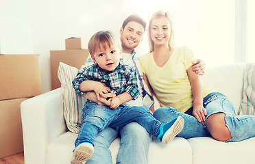 Image showing happy family with boxes moving to new home