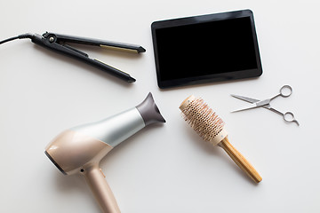 Image showing tablet pc, scissors, hairdryer, hot iron and brush