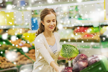 Image showing happy woman buying savoy at grocery store