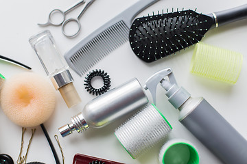 Image showing hair brush, styling sprays, curlers and pins