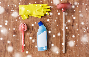 Image showing plunger with toilet cleaning stuff on wood