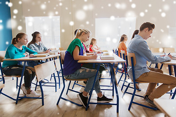 Image showing group of students with books writing school test