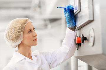 Image showing woman programming computer at ice cream factory