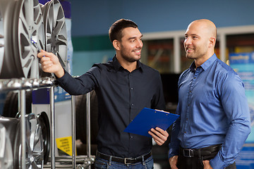 Image showing customer and salesman at car service or auto store