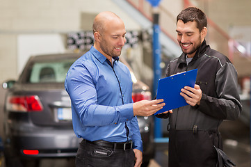 Image showing auto mechanic and customer at car shop