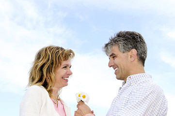 Image showing Mature romantic couple with flowers