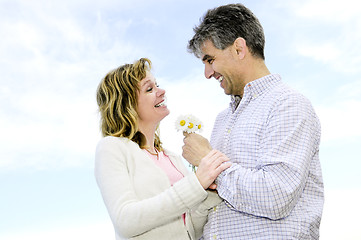 Image showing Mature romantic couple with flowers