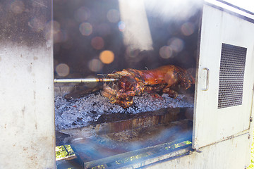 Image showing Traditional balkan dish - whole piglet grilled on the open fire.