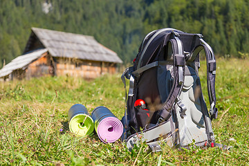 Image showing Backpack and yoga mats on mountain meadow.