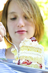 Image showing Girl eating a cake