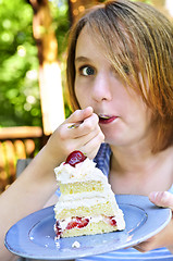 Image showing Girl eating a cake