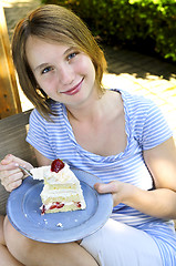 Image showing Girl eating a cake