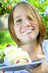 Image showing Girl eating a cake