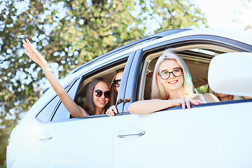 Image showing The young women in the car smiling