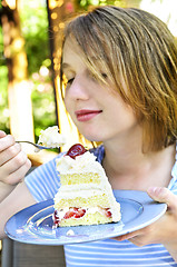 Image showing Girl eating a cake