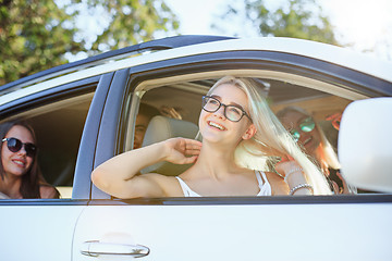 Image showing The young women in the car smiling