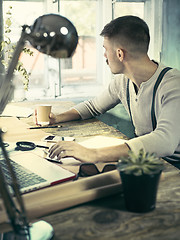 Image showing Architect working on drawing table in office