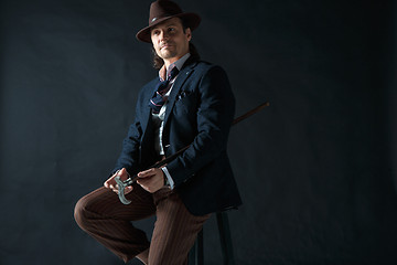 Image showing Young man portrait with hat on gray studio background.