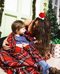 Image showing happy smiling family on Christmas at house with gifts, young mot