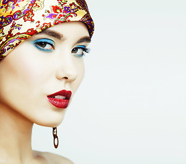 Image showing young pretty modern girl with bright shawl on head emotional posing isolated on white background, asian people ethnicity