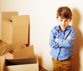 Image showing little cute boy in empty room, remoove to new house. home alone,