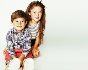 Image showing little cute boy and girl hugging playing on white background, ha