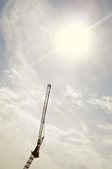 Image showing Silhouette of construction crane against the sunny sky