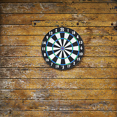 Image showing Dart board on a wooden grunge wall