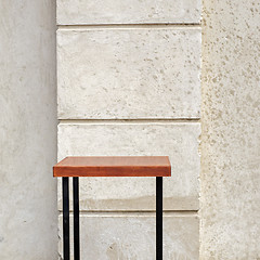 Image showing outdoor table near the stucco wall