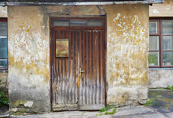 Image showing wooden plank door with post box, dirty stucco wall background