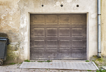 Image showing Garage wooden door, dirty cracked wall background