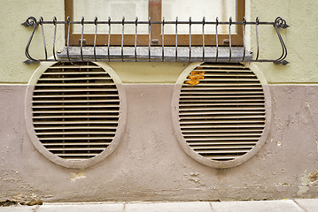 Image showing abandoned grunge cracked stucco wall with ventilation grille holes