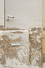 Image showing Security camera CCTV and metal plate for street name on the wall