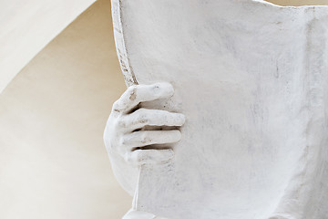 Image showing stone statue detail of human hand holding book