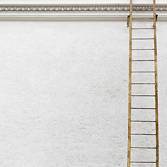 Image showing White stucco wall with metal ladder