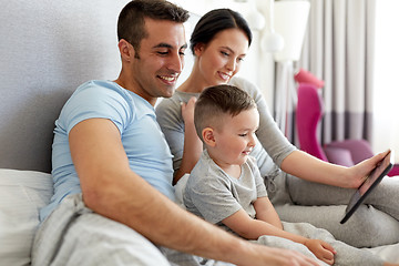 Image showing happy family with tablet pc in bed at home