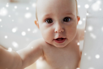 Image showing close up of happy little baby over snow