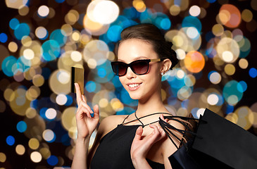Image showing happy woman with credit card and shopping bags