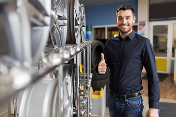 Image showing male customer choosing wheel rims at car service