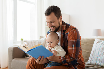 Image showing happy father and little baby boy with book at home