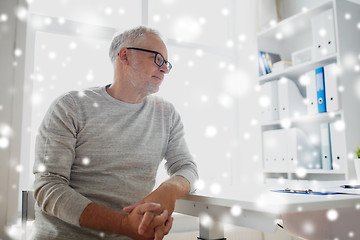 Image showing senior man sitting at medical office table